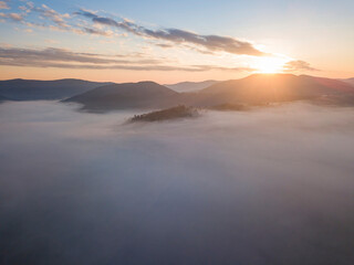 Sunrise over the fog in the Ukrainian Carpathians. Aerial drone view.