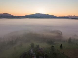 Sunrise over the fog in the Ukrainian Carpathians. Aerial drone view.