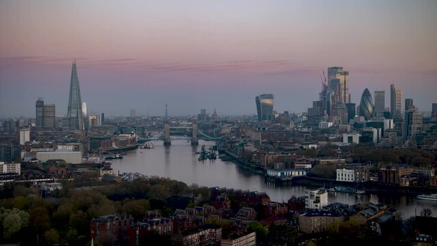 Panoramic sunrise to day time lapse view of the skyline of London with Tower Bridge, Thames river and the skyscrapers of the City, England