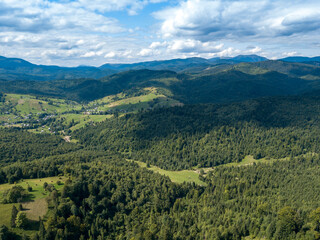Obraz premium Green mountains of Ukrainian Carpathians in summer. Coniferous trees on the slopes. Aerial drone view.