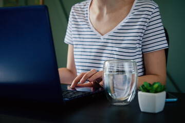 Caucasian woman typing with laptop keyboard at home office workplace. Freelancer remotely working