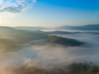 Obraz premium Morning fog in the Ukrainian Carpathians. Aerial drone view.
