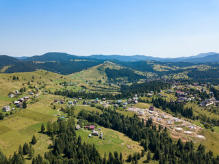 Fototapeta premium Mountain settlement in the Ukrainian Carpathians. Aerial drone view.