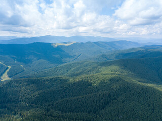 Obraz premium Green mountains of Ukrainian Carpathians in summer. Sunny day, rare clouds. Aerial drone view.