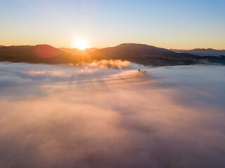 Obraz premium Sunrise over the fog in the Ukrainian Carpathians. Aerial drone view.
