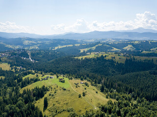 Fototapeta premium Green mountains of Ukrainian Carpathians in summer. Sunny day. Aerial drone view.