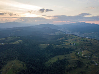 Fototapeta premium Sunset over the mountains in the Ukrainian Carpathians. Evening. Aerial drone view.