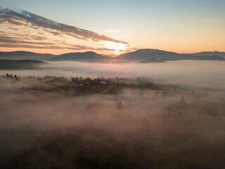 Obraz premium Sunrise over the fog in the Ukrainian Carpathians. Aerial drone view.