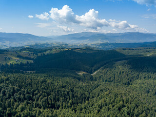 Green mountains of Ukrainian Carpathians in summer. Sunny day. Aerial drone view.