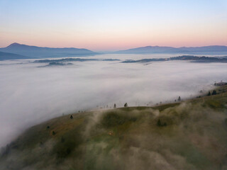 Sunrise over the fog in the Ukrainian Carpathians. Aerial drone view.