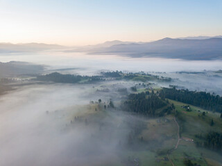 Sunrise over the fog in the Ukrainian Carpathians. Aerial drone view.