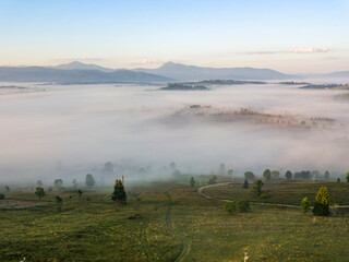 Sunrise over the fog in the Ukrainian Carpathians. Aerial drone view.