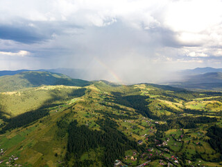 Obraz premium Rainbow in the mountains of the Ukrainian Carpathians. Aerial drone view.
