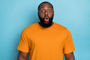 Photo of impressed funny guy dressed orange t-shirt big eyes open mouth isolated blue color background