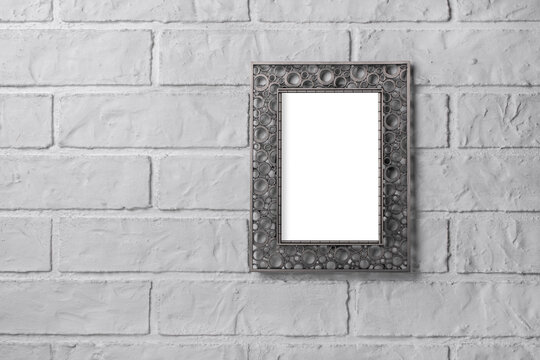 Photo frame on a brick wall.