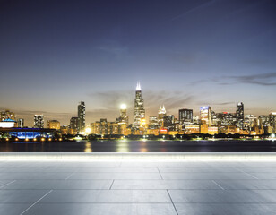 Fototapeta na wymiar Empty concrete embankment on the background of a beautiful blurry Chicago city skyline at evening, mockup