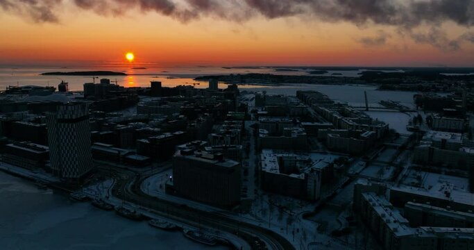 Aerial view of the cityscape of Jatkasaari, winter sunset in Helsinki - circling, drone shot