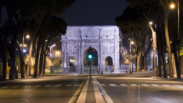 Timelapse of road traffic in front of the Arch of Constantine in Rome at night