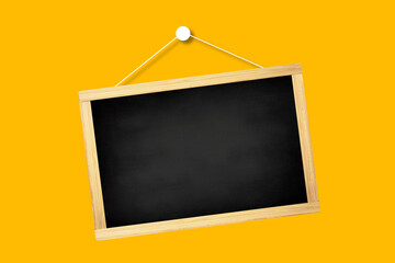 Blank vintage chalkboard with wooden frame and rope for hanging, isolated on yellow background