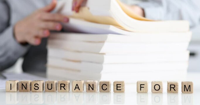 Agent leafs through insurance form in office closeup