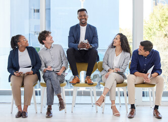 Im here to prove why Im the best. Portrait of a young businessman sitting on a chair alongside candidates in an office.