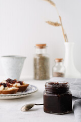 onion marmalade (Onion confiture). onion confit in a glass jar on a white background.