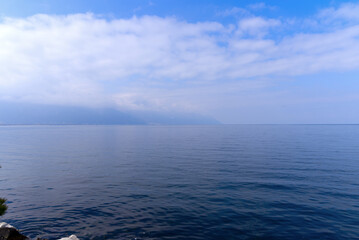 Lakeshore with riviera and skyline at City of Montreux with Lake Geneva on a cloudy spring day. Photo taken April 4th, 2022, Montreux, Switzerland.