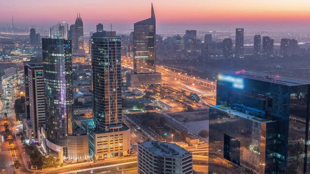 Aerial view of media city and al barsha heights district area night to day timelapse from Dubai marina.