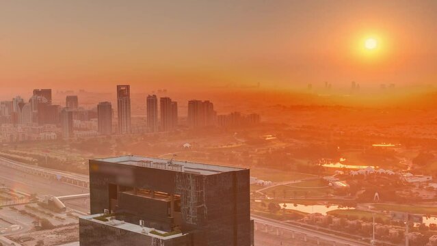 Sunrise over media city and al barsha heights district area night to day timelapse from Dubai marina.