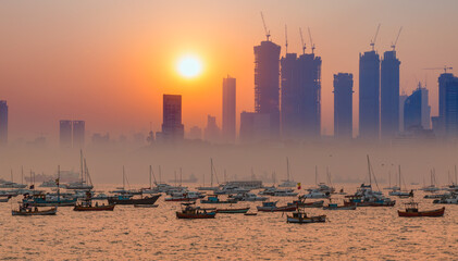Air pollution concept - Modern highrise rich buildings and poor slums at sunset - Mumbai, india 