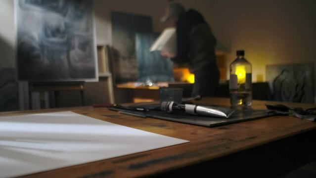 The artist makes a sketch on a paper.  Art studio, the process of creating a picture close up.