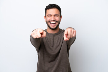 Young Brazilian man isolated on white background surprised and pointing front