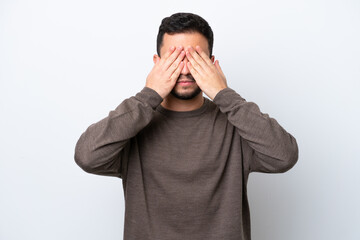 Young Brazilian man isolated on white background covering eyes by hands