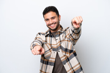 Young Brazilian man isolated on white background pointing front with happy expression