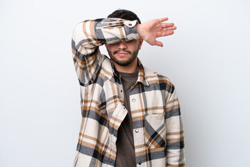 Fototapeta premium Young Brazilian man isolated on white background covering eyes by hands