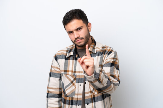 Young Brazilian man isolated on white background frustrated and pointing to the front