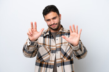 Young Brazilian man isolated on white background counting eight with fingers