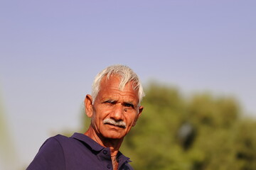 portrait Photo of an Indian farmer with blue sky background