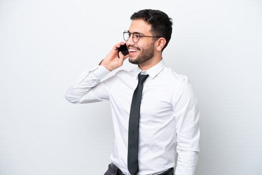 Business Brazilian Man Isolated On White Background Keeping A Conversation With The Mobile Phone