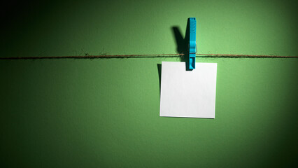 Paper sheets on a rope secured with clothespins