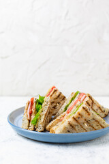 sandwich with ham cheese tomatoes lettuce onions on plate. Classic club sandwich with whole grain bread