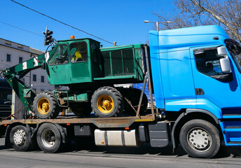 Excavator vehicle on a truck