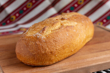 fresh white bread  on brown wood cutting board