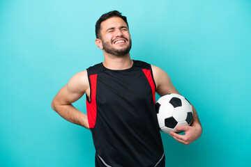 Young football player Brazilian man isolated on blue background suffering from backache for having made an effort