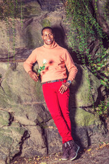 Young African American Man holding white flower, waiting for you at park in New York