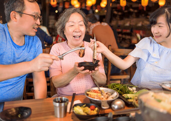 Happy family celebrating mothers day at restaurant