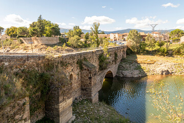 Fototapeta na wymiar Buitrago del Lozoya, Spain. The Puente del Arrabal, an old medieval bridge that connects the Old Town with the Andarrio suburb