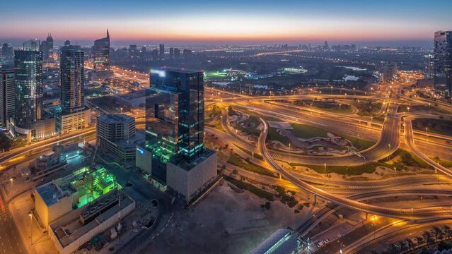 Aerial view of media city and al barsha heights district area night to day timelapse from Dubai marina.