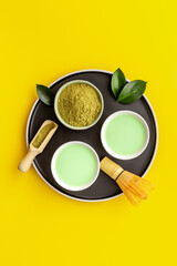 Green hot tea in bowls with matcha powder, top view