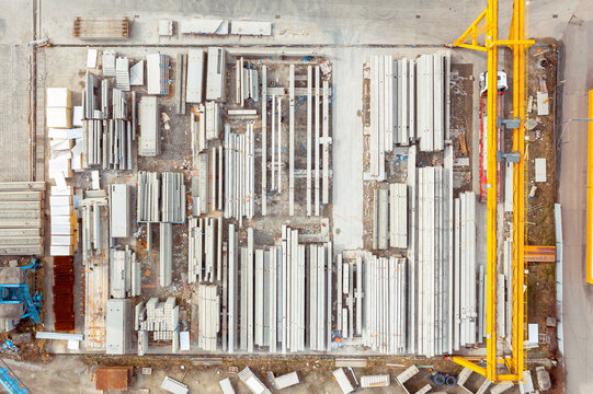Many concrete blocks of different sizes stand in warehouses, the production of concrete panels for the construction of houses, aerial view © Vladyslav
